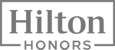 The image displays the "Hilton Honors" logo, featuring bold text enclosed in a rectangular border.