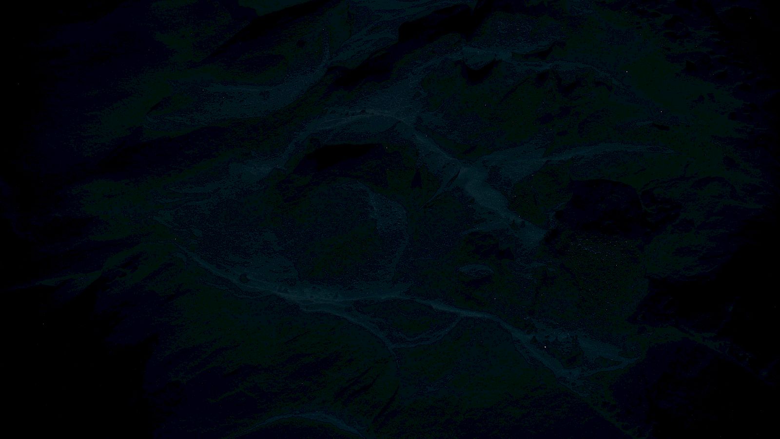 The image is very dark and abstract, making it difficult to distinguish specific details or elements.